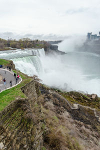 Scenic view of waterfall against sky