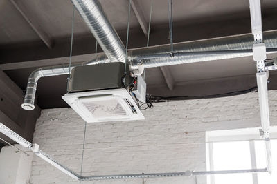 Low angle view of lighting equipment hanging on ceiling