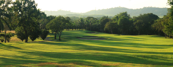 Scenic view of golf course against sky