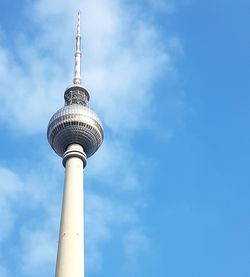 Low angle view of communications tower against sky