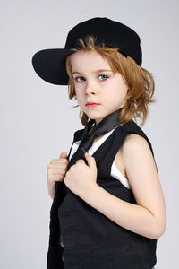 Portrait of beautiful woman standing against white background