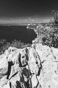 High angle view of rocks on beach against sky