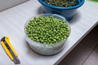 High angle view of green peas in bowl on table