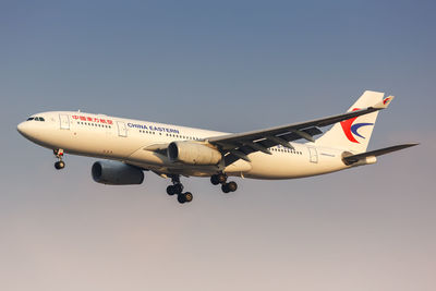 Airplane flying against clear blue sky