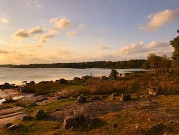 Scenic view of river against sky at sunset