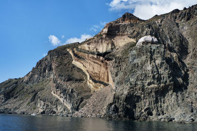 Rock formations in sea against sky