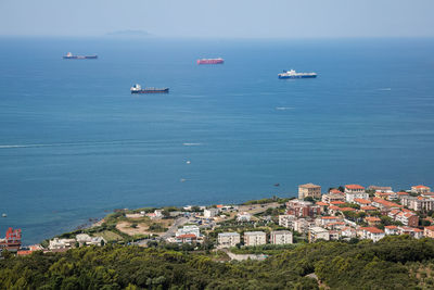 Aerial view of empty cargo ships near the coast with calm seas.
