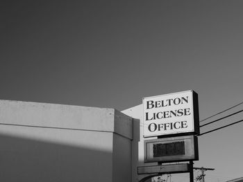 Low angle view of information sign against clear sky