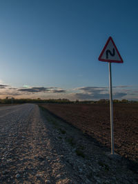 Road sign against clear sky