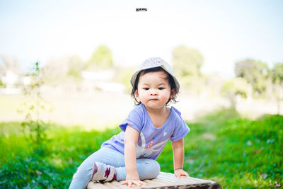 Cute girl sitting on field