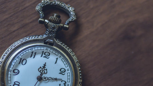 Close-up of clock on table