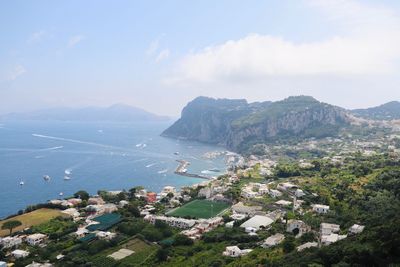 High angle view of townscape by sea against sky