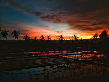 Scenic view of lake against orange sky