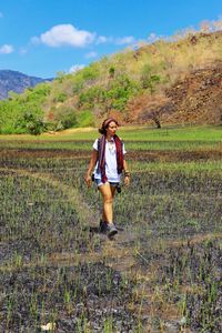 Full length of woman standing on grassy field