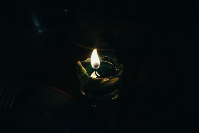 Close-up of illuminated light bulb in darkroom