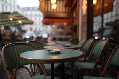 Close-up of empty chairs and table in cafe