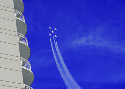 Low angle view of vapor trail against blue sky