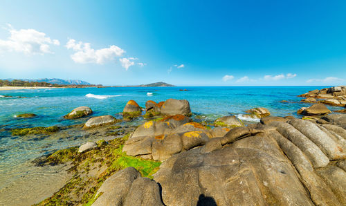 Rocks on beach against sky