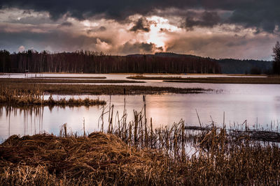 Scenic view of lake against cloudy sky