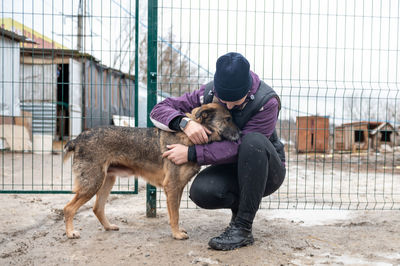 Girl volunteer in the nursery for dogs. shelter for stray dogs.