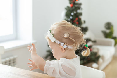 Side view of young woman holding bouquet