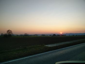 Cars on road at sunset