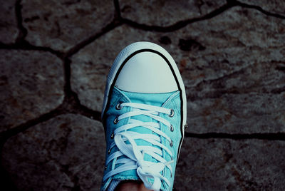 Low section of person standing on tiled floor