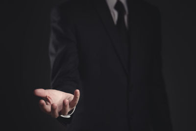 Close-up of man hand on black background