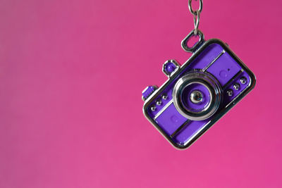 Close-up of electric lamp against pink background