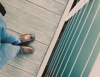 Low section of person standing on tiled floor