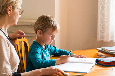 Boy and book on table