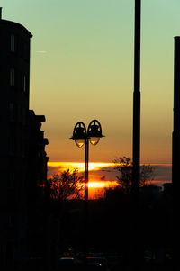 Street light in city during sunset