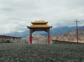 View of cross against cloudy sky