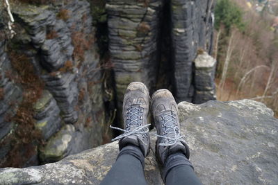 Low section of person standing on rock