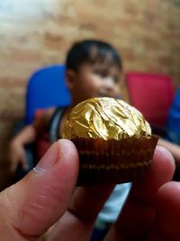 Close-up of hand holding ice cream