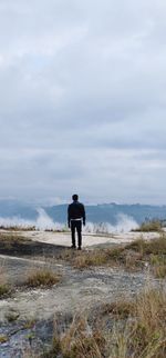 Rear view of man standing against sky
