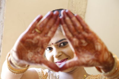 Close-up of young woman's hands in henna tatoos