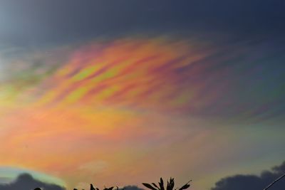 Low angle view of rainbow against sky during sunset