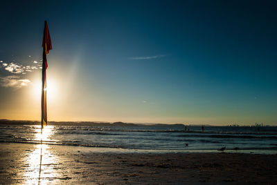 Scenic view of beach against sky during sunset