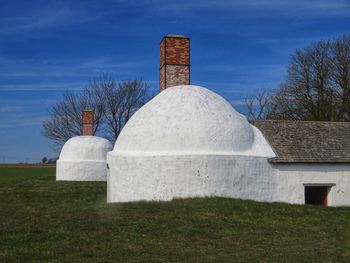 Stone structure on field against sky