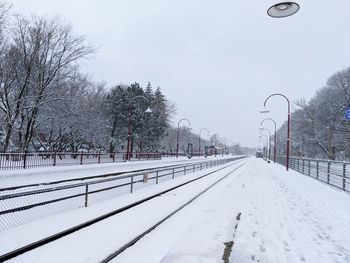 Snow covered street against sky