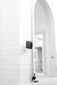 Man standing against wall in building