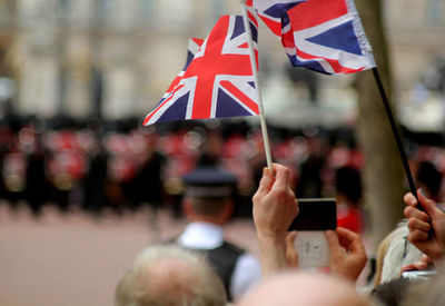Cropped hands holding british flags