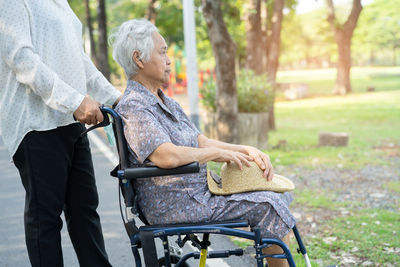 Side view of man sitting on field