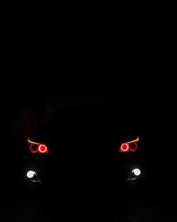 Close-up of illuminated red car at night