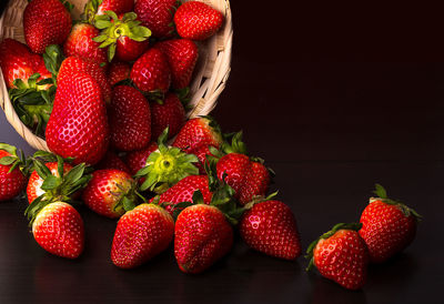 High angle view of strawberries in basket on table