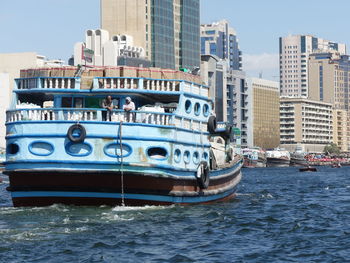 View of boats in sea against buildings