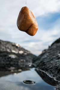 Close-up of chocolate in water against sky
