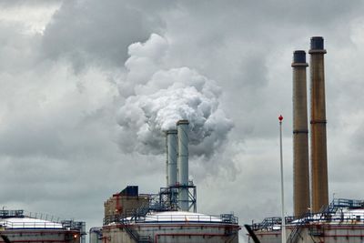 Low angle view of construction site against cloudy sky