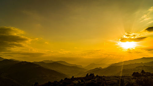 Scenic view of mountains against sky during sunset